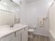 Clean bathroom with a shower-tub combo, white cabinets, a sink with a mirror, and floral-themed towels at 2555 Hampton Rd # 2308, Henderson, NV 89052