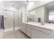 Bright bathroom featuring double sinks, a spacious shower with glass doors, and modern fixtures at 2555 Hampton Rd # 2308, Henderson, NV 89052