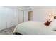 Bright bedroom featuring a bed with a decorative comforter, closet space, and a wooden nightstand with a lamp at 2555 Hampton Rd # 2308, Henderson, NV 89052