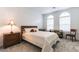 Comfortable bedroom with arched windows, a bed with decorative pillows, and wooden nightstands at 2555 Hampton Rd # 2308, Henderson, NV 89052