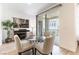 Cozy dining area with a round glass table, slider doors, and light neutral tones at 2555 Hampton Rd # 2308, Henderson, NV 89052