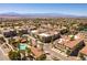 View of a residential community featuring tile roofs, mature trees, and lush landscaping at 2555 Hampton Rd # 2308, Henderson, NV 89052