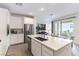 Contemporary kitchen with stainless steel appliances, white cabinets, and a large center island with seating at 2555 Hampton Rd # 2308, Henderson, NV 89052
