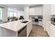 Beautiful kitchen featuring a stainless steel dishwasher, white cabinets, quartz countertop and a breakfast bar at 2555 Hampton Rd # 2308, Henderson, NV 89052