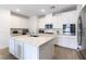 Modern kitchen featuring white cabinets, stainless steel appliances, and a center island with quartz countertop at 2555 Hampton Rd # 2308, Henderson, NV 89052