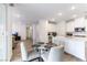 Open-concept kitchen with white cabinets, stainless steel appliances and a breakfast table with seating for four at 2555 Hampton Rd # 2308, Henderson, NV 89052