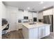 Bright kitchen featuring white cabinets, stainless steel appliances and a large center island with a marble countertop at 2555 Hampton Rd # 2308, Henderson, NV 89052