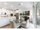 Bright kitchen and dining area featuring stainless steel appliances, white cabinets and a glass table at 2555 Hampton Rd # 2308, Henderson, NV 89052