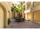 Charming outdoor patio area with elegant dining furniture and lush greenery, perfect for entertaining guests at 2555 Hampton Rd # 2308, Henderson, NV 89052