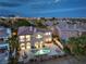 Captivating aerial perspective of an estate with an inviting backyard pool, meticulously manicured landscaping, and an tiled roof at 2571 Red Springs Dr, Las Vegas, NV 89135