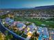 Aerial view of a community with lush golf course, beautiful homes, and mountain views at 2571 Red Springs Dr, Las Vegas, NV 89135