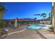 Backyard with private pool and landscaping featuring desert views and patio seating at 2571 Red Springs Dr, Las Vegas, NV 89135