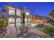 Stunning backyard and pool area with patio seating, landscaping, and a built-in hot tub at 2571 Red Springs Dr, Las Vegas, NV 89135