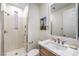 This bathroom offers a tiled walk-in shower, granite counters with a modern faucet, and a framed mirror at 2571 Red Springs Dr, Las Vegas, NV 89135