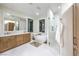 Luxurious bathroom featuring a soaking tub, glass shower, dual sinks, and modern fixtures at 2571 Red Springs Dr, Las Vegas, NV 89135