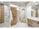 Bright bathroom featuring a stylish vanity, walk-in shower, and a linen cabinet for storage at 2571 Red Springs Dr, Las Vegas, NV 89135