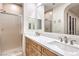 Bathroom featuring double sink vanity, framed mirrors and glass enclosed shower at 2571 Red Springs Dr, Las Vegas, NV 89135