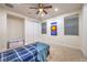 Neutral bedroom featuring a ceiling fan, large windows, and a closet with sliding doors at 2571 Red Springs Dr, Las Vegas, NV 89135