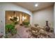 Covered outdoor patio featuring a seating area, tiled floor, and serene garden views at 2571 Red Springs Dr, Las Vegas, NV 89135