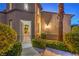 Inviting front entrance with an open gate, mature landscaping, and warm exterior lighting at 2571 Red Springs Dr, Las Vegas, NV 89135