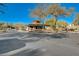 A cozy guard house with a stone facade stands at the entrance to a gated community, ensuring privacy and security at 2571 Red Springs Dr, Las Vegas, NV 89135