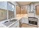 Modern kitchen features stainless steel appliances, white backsplash, and wood cabinets at 2571 Red Springs Dr, Las Vegas, NV 89135