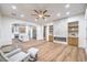 Open-concept living room with fireplace and hardwood floors flows into modern kitchen at 2571 Red Springs Dr, Las Vegas, NV 89135