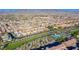 An aerial view of a vibrant neighborhood featuring green spaces, a community pool, and well-maintained homes at 2932 Tranquil Brook Ave, Henderson, NV 89044