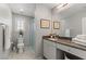 Bright bathroom with a granite-topped vanity, a framed mirror, and a separate shower space at 2932 Tranquil Brook Ave, Henderson, NV 89044