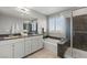 Elegant bathroom boasts dual sinks, soaking tub, and a separate glass-enclosed shower, with bright natural light at 2932 Tranquil Brook Ave, Henderson, NV 89044