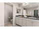 Modern bathroom with dual sinks, a tub, glass shower, and toilet for a complete and convenient space at 2932 Tranquil Brook Ave, Henderson, NV 89044