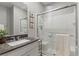 Well-lit bathroom featuring a glass-enclosed shower and a stylish vanity with granite countertops at 2932 Tranquil Brook Ave, Henderson, NV 89044