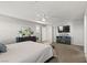 Bright bedroom featuring a TV, ceiling fan, neutral paint, and gray carpeting for a cozy, modern living space at 2932 Tranquil Brook Ave, Henderson, NV 89044
