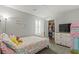 Cozy bedroom with a colorful bed, a TV, and a glimpse into the organized closet at 2932 Tranquil Brook Ave, Henderson, NV 89044