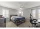Comfortable bedroom featuring neutral walls, carpeted floors, and a cozy queen-sized bed with a ceiling fan at 2932 Tranquil Brook Ave, Henderson, NV 89044