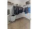 Walk-in closet featuring ample storage space with racks for hanging clothes and shelving for shoes at 2932 Tranquil Brook Ave, Henderson, NV 89044