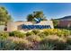 Inspiring community sign with lush landscaping, blue bird emblem, and bright blue neighborhood lettering at 2932 Tranquil Brook Ave, Henderson, NV 89044