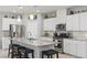 Modern kitchen with stainless steel appliances, granite countertops, white cabinets, and a large island with seating at 2932 Tranquil Brook Ave, Henderson, NV 89044