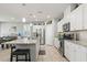 Bright kitchen with white cabinets, stainless steel appliances, granite countertops, and a kitchen island with barstool seating at 2932 Tranquil Brook Ave, Henderson, NV 89044
