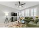 Cozy living room with tile floors, bright windows with shutters, and comfortable seating at 2932 Tranquil Brook Ave, Henderson, NV 89044
