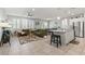 Open-concept living area featuring tile flooring, a modern ceiling fan, and an adjacent kitchen and dining space at 2932 Tranquil Brook Ave, Henderson, NV 89044