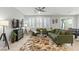 Bright living room featuring stylish decor, large windows, and a ceiling fan at 2932 Tranquil Brook Ave, Henderson, NV 89044