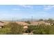 Residential rooftop view showcasing tile roofs, lush greenery, and distant mountain views at 2932 Tranquil Brook Ave, Henderson, NV 89044