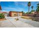 Spacious backyard features a concrete patio, block wall, and large shed for storage at 3016 Light Wind Ct, Las Vegas, NV 89108