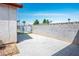 Spacious backyard features a concrete patio, block wall, and mature trees at 3016 Light Wind Ct, Las Vegas, NV 89108
