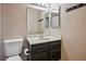 Standard bathroom with single sink vanity with dark wood cabinets and neutral wall paint at 3016 Light Wind Ct, Las Vegas, NV 89108