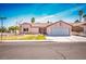 Inviting single-story home with a two-car garage, complemented by a bright and airy sky at 3016 Light Wind Ct, Las Vegas, NV 89108