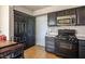 Cozy kitchen with black cabinetry, stainless steel microwave, and gas range at 3016 Light Wind Ct, Las Vegas, NV 89108