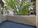Balcony view featuring a stucco wall and trees at 3038 Tarpon Dr # 203, Las Vegas, NV 89120
