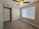Cozy bedroom with wood-look flooring, closet and a ceiling fan at 3038 Tarpon Dr # 203, Las Vegas, NV 89120